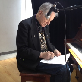 David Amram takes a moment to pen some last minute changes to music.